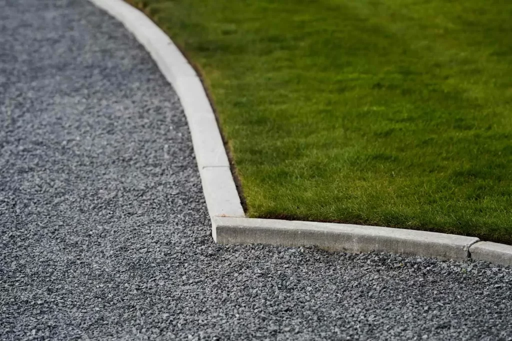 concrete edging between gravel driveway and grass yard in richmond va